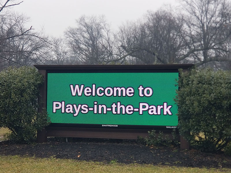 Crew lifting message center into place