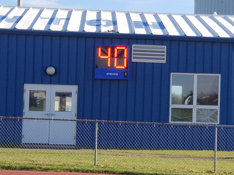 End-of-period light mounted on scoreboard