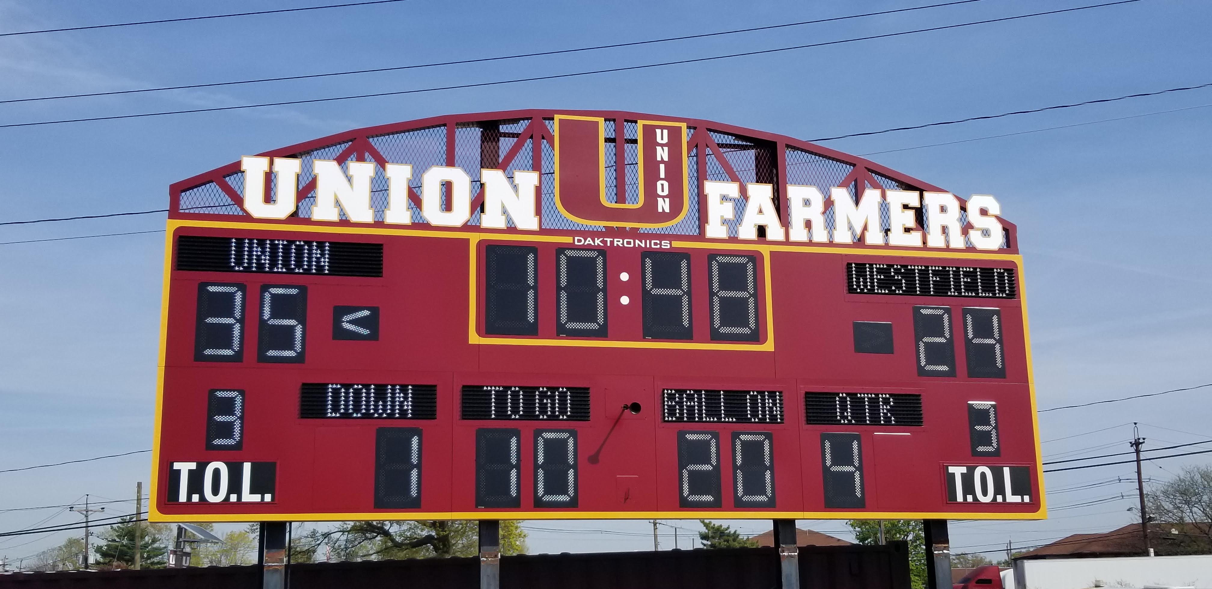 Technicians securing scoreboard panels